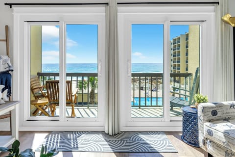 Step through your patio doors onto your private balcony where ocean waves meet endless blue skies, creating your perfect seaside sanctuary.