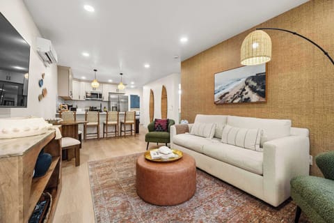 This bright, light filled space serves as the heart of the home, providing a stylish and functional area to unwind, dine, and relax.