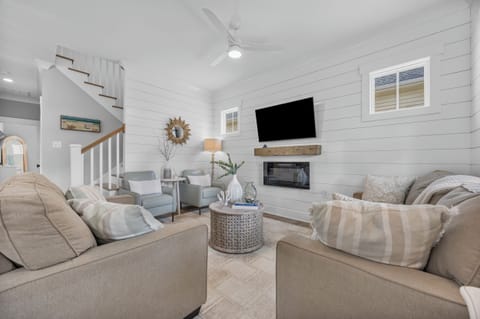 Cozy coastal-inspired living room with comfortable seating provides the perfect place to unwind with family and friends.