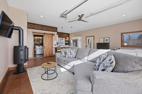 Spacious couch and wood stove for relaxing