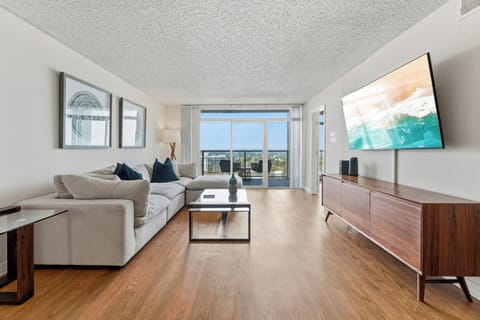 Spacious, Scandi-inspired lounge with a large smart TV and sleek finishes.
