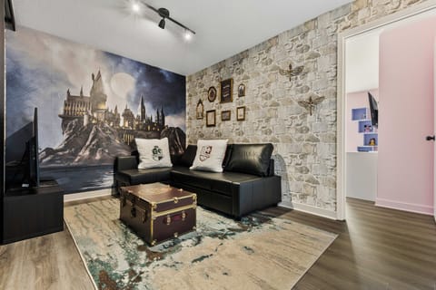 Cozy living area with a themed castle mural and stone accent wall.