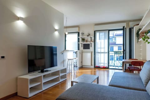 Bright living area with TV and natural light, perfect for relaxing
