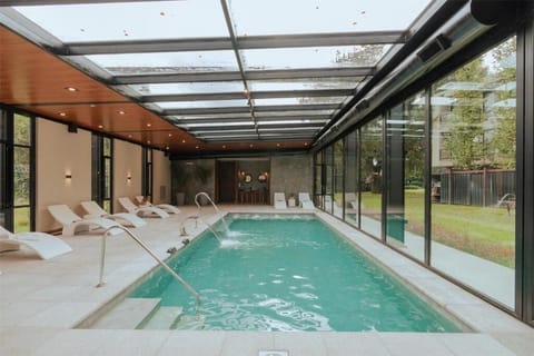 Dive into calm waters framed by sleek floor-to-ceiling glass.