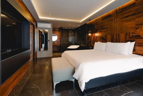 Stretch out under soft cove lighting in this sleek suite.