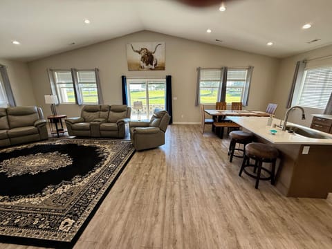 Open dining, kitchen and living room with patio to the golf course