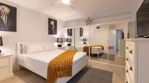 Comfortable primary suite featuring a large bed, plenty of storage, and easy layout for relaxing or getting ready.