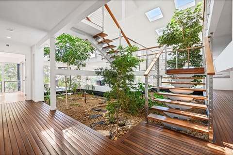 Bright multi‑level home featuring a central indoor garden and airy open spaces for a relaxing stay.