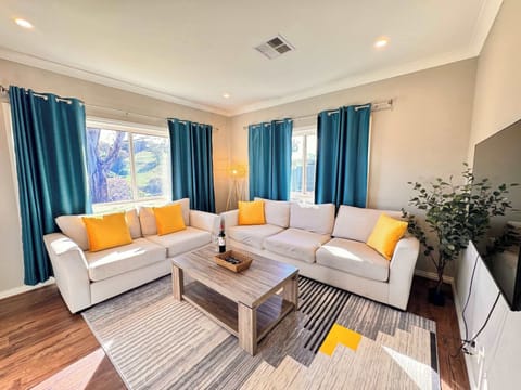 Living room with plush sofas and 50" wall mounted smart TV