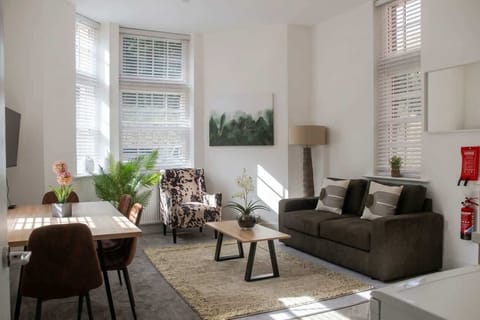 Light-filled living space with comfortable seating and dining area—perfect for relaxing, working, or enjoying meals together.