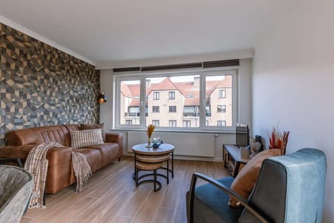 Modern living room with geometric accent wall and large window views