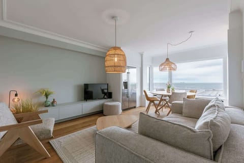 Modern living room with ocean views and natural wood accents.