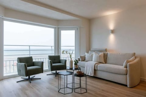 Bright living room with panoramic sea views and natural daylight.