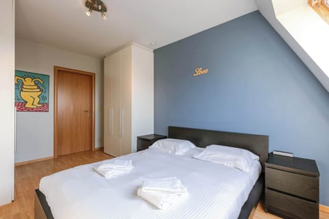 Bedroom with large bed and soft lighting.