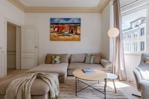Bright living room with a comfortable sectional sofa and natural light from a large window.