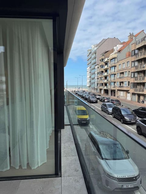 Street & Building View: Modern seaside neighborhood with charming streets just steps from the beach.