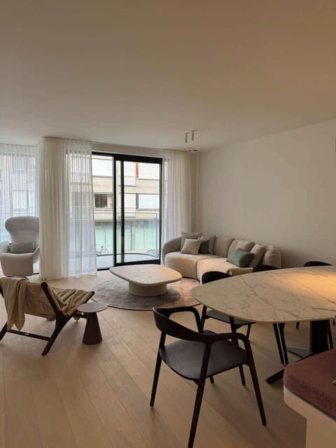 Modern living room with a curved sofa and large windows letting in natural light