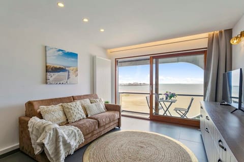 Cozy living room with a beach view and balcony seating for relaxing moments.