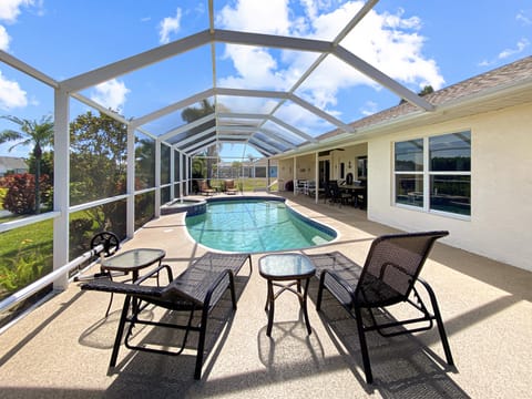 Relax by the private screened pool with comfortable loungers and sunny views.