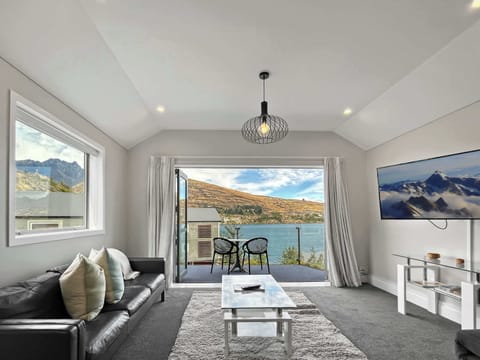 Bright living with balcony and lake views