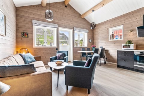 Living and dining room with heated floor, fireplace and a view of Reinebringen