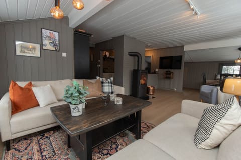 Fireplace warmth, comfy sofas, and a TV – just sit back and enjoy!