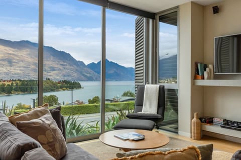 Lake and mountains from the lounge - the view that anchors the whole apartment