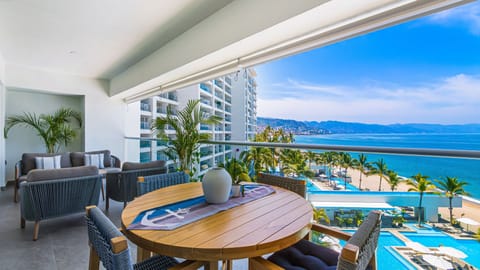Take in breathtaking panoramic ocean views from your private balcony, the perfect space for morning coffee, sunset drinks, and relaxing in the sea breeze.