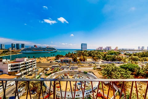 Look out from the balcony to catch a breathtaking view of the sparkling blue ocean bay, complete with passing cruise ships at the city port.