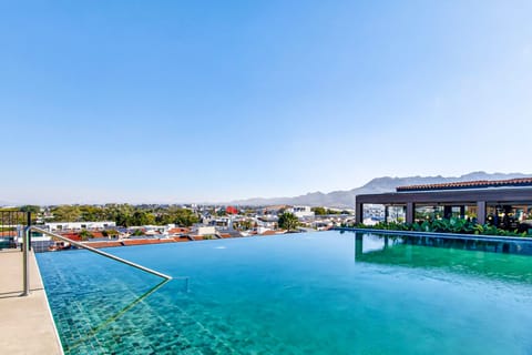 Stunning rooftop infinity pool with panoramic city and mountain views perfect for relaxing, swimming, and enjoying Puerto Vallarta sunsets.
