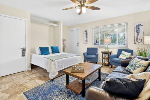 Unwind in your coastal-inspired studio with plush seating, nautical touches, and a Murphy bed that transforms your space.