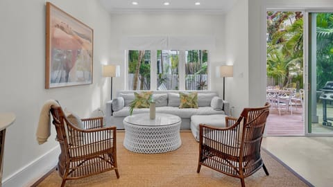 Sunlight pours into the main living space, which has soaring ceilings and chic, contemporary design...