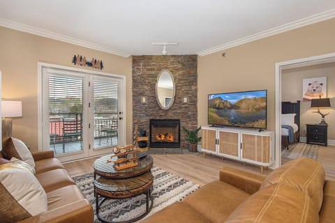 Unwind in your cozy living room with crackling fireplace, plush leather seating, and stunning mountain views on the big screen TV.
