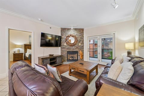Sink into plush leather seating while the stone fireplace creates a cozy glow for your evening relaxation.