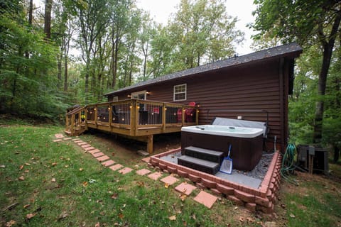 Cabin Deck with a private hot tub—made for quiet evenings under the trees.