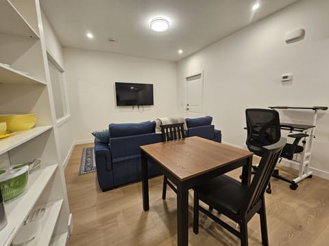 Your Calgary home base. Relax in our bright, open-concept living space, complete with a cozy sofa and a flat-screen TV for movie nights.