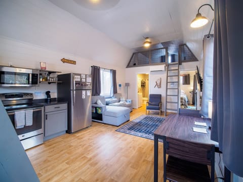 Open-concept kitchen/dining/living room.  Living room features queen sofa bed