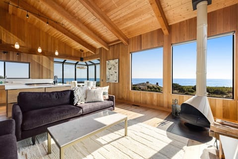 Relax and unwind in this inviting living room, where the ocean view and warm wood accents create a serene retreat.