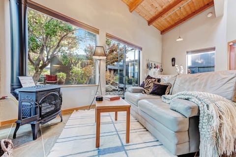 Cozy up by the gas fireplace as natural light pours into the living room, creating a warm and inviting space.