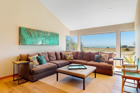 Gather your loved ones in this cozy living room, where natural light floods in and the ocean view sets the perfect backdrop.