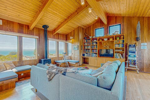 Breathe in the coastal air as you lounge in the cozy living room, where every window frames a piece of paradise.