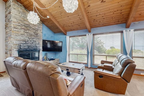 Relax in the inviting living room, where the warmth of the fireplace and stunning views create the perfect space for cozy evenings.