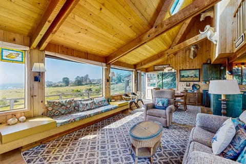 Morning light fills the cozy living room, creating a perfect spot to unwind with a book and enjoy the tranquil surroundings.