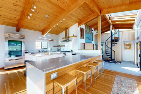 Craft your favorite meals in this spacious kitchen, where the ocean view inspires culinary creativity and shared moments.