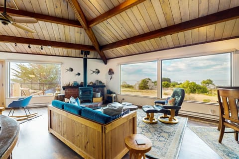 Sunlight dances across the spacious living room, inviting you to relax and soak in the ocean views.