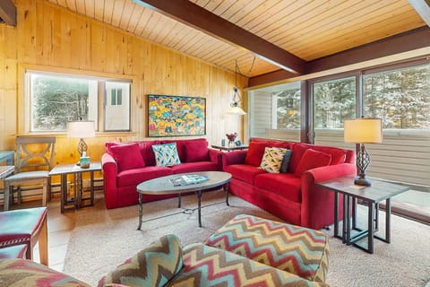 Relax in the bright living room beneath soaring cathedral ceilings