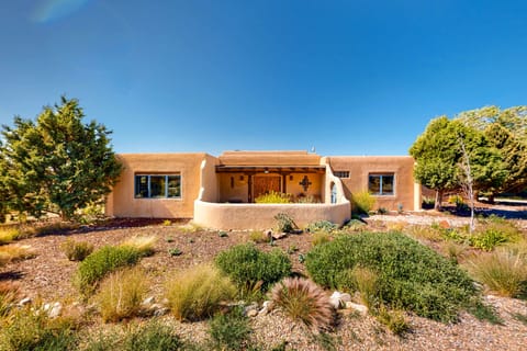 Arrive at Casa Luna framed by mature high-desert landscaping