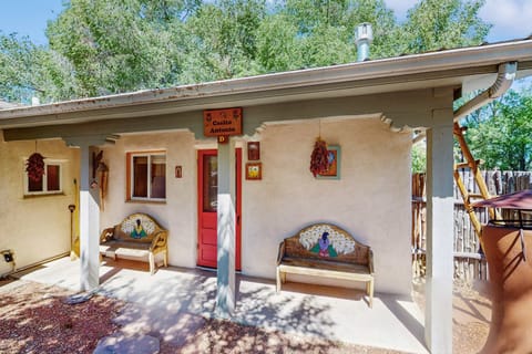 Find Casita Antonio behind its painted peacock benches and red door