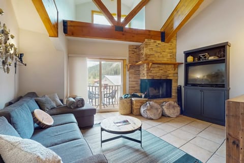 Cozy up by the wood-burning fireplace under a vaulted, beamed ceiling