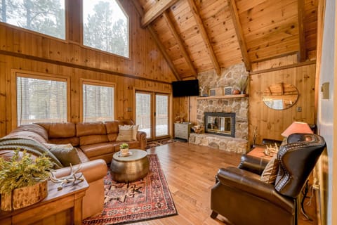 The heart of Coyote Cabin. Gather beneath soaring vaulted ceilings, cozy up by the wood-burning fireplace, and enjoy quality time surrounded by warm mountain charm.